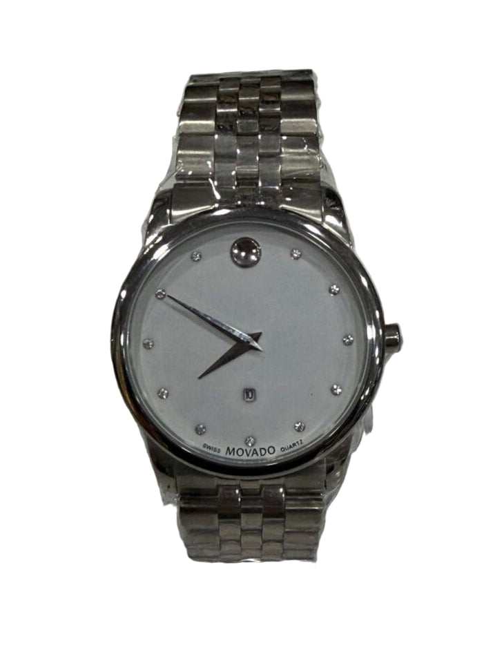 Silver watch on a clear stand with a patterned background