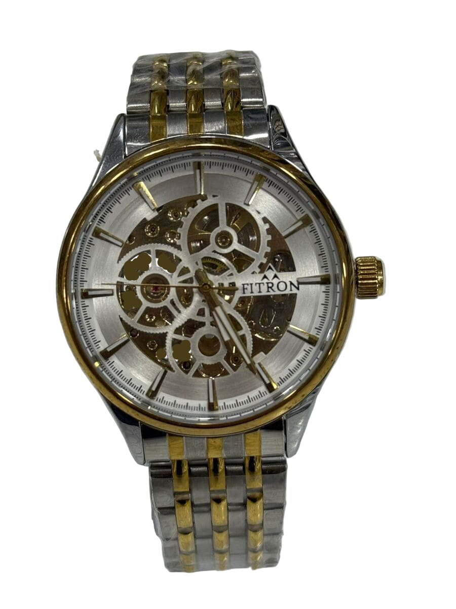 Silver and gold watch with visible brand name on a textured white background